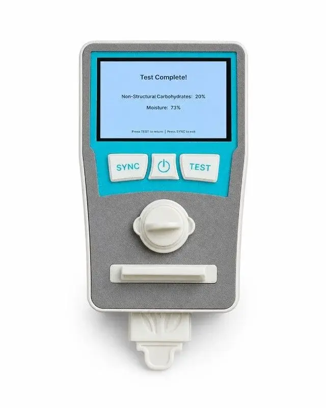 The AnFiTest handheld device displaying a completed test with non-structural carbohydrate and moisture readings